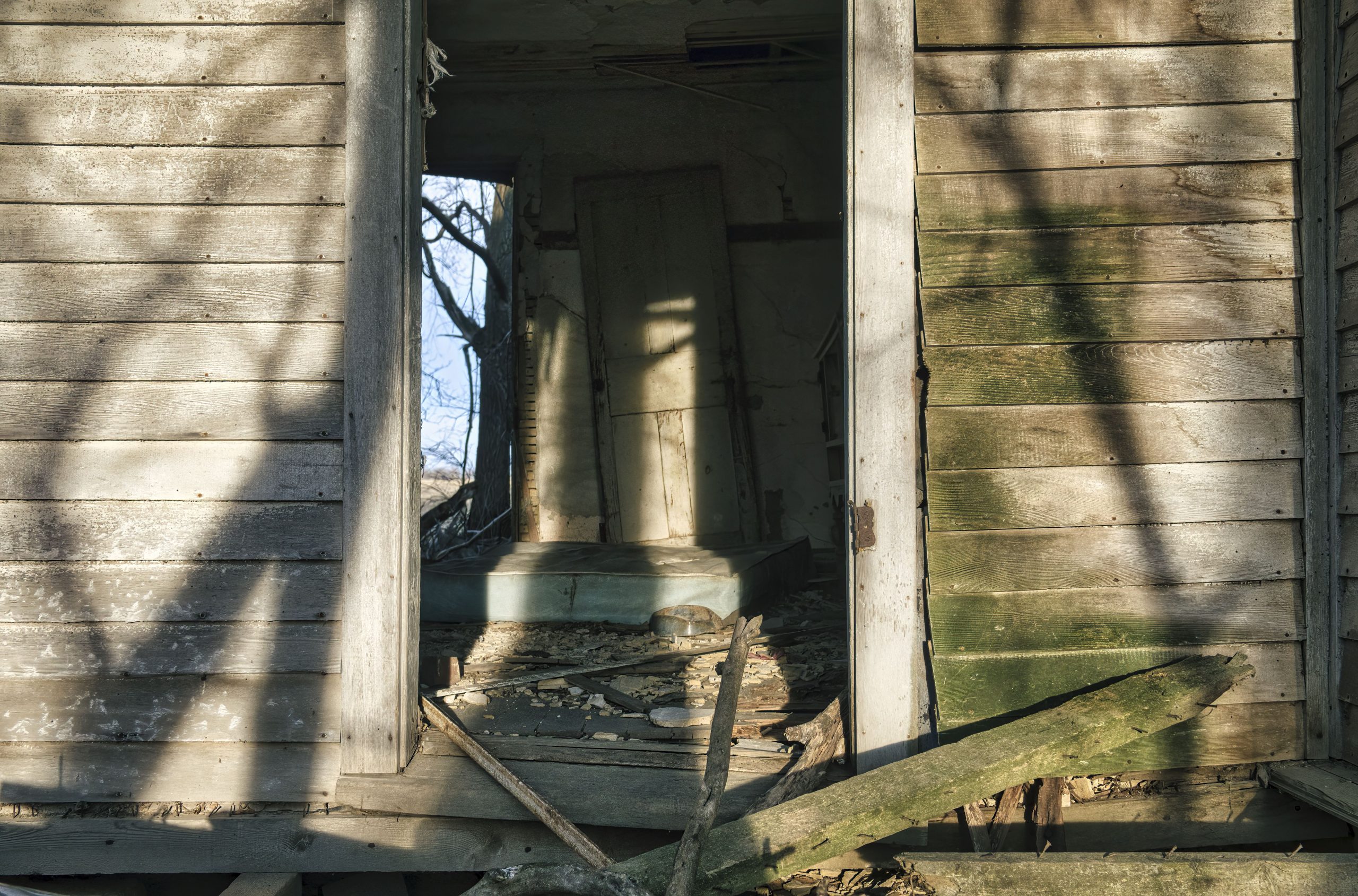 Maison en bois décrépite avec porte cassée